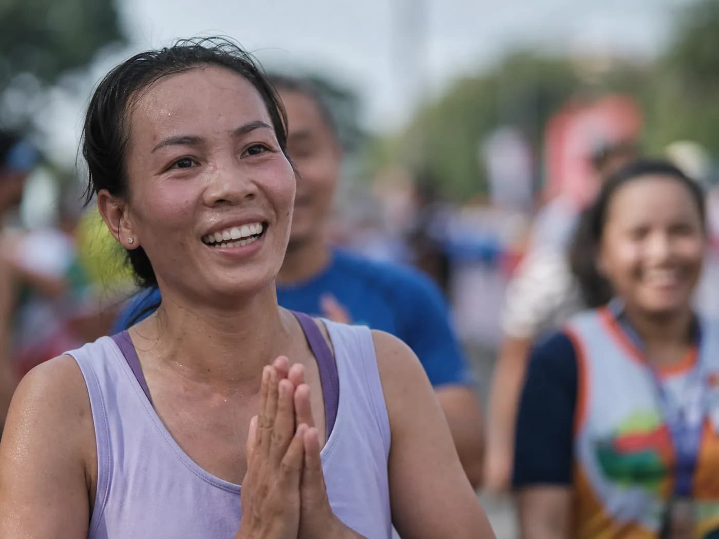 A runner's face at a finish line, sharp against a blurred crowd